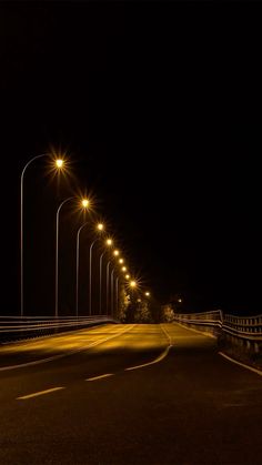 an empty street at night with lights on