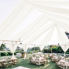 a large tent with tables and chairs set up for an event