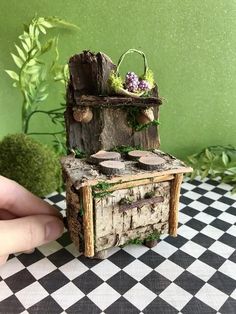 a miniature stove made out of wood with moss growing on it