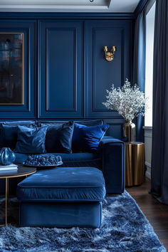 a living room with blue walls and rugs on the floor next to a couch