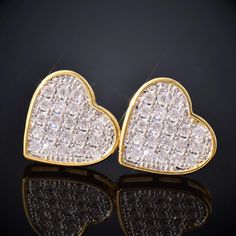 Elevate your look with our stunning 14mm Heart Pave Earrings. Crafted with precision and adorned with sparkling stones, these heart-shaped earrings are the epitome of elegance and charm. Perfect for adding a touch of glamour to any outfit, whether it's a casual day out or a special occasion. Embrace timeless beauty and express your style with these exquisite earrings that capture hearts and turn heads wherever you go. Product Type: Earring Gender: Unisex Material: 18k Gold Plated Heart-shaped Cubic Zirconia Wedding Earrings, Elegant Heart-shaped Bling Jewelry, Heart-shaped Earrings With Sparkling Stones For Wedding, Double Heart Earrings With Cubic Zirconia Heart Charm, Double Heart Charm Earrings With Cubic Zirconia, Gold Heart-shaped Cubic Zirconia Earrings, Luxury Cubic Zirconia Double Heart Earrings With Heart Charm, Heart-shaped Diamond Earrings With Accents For Valentine's Day, Heart Charm Cubic Zirconia Drop Earrings