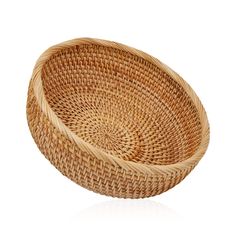 a round woven basket on a white background