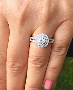 a woman's hand with a diamond ring on it