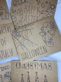 four handmade christmas cards on top of each other with the words merry written in black ink