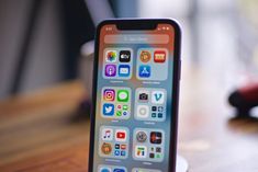 an iphone sitting on top of a wooden table