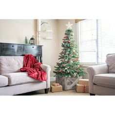 a living room with a christmas tree in the corner