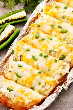 baked potato casserole with cheese and green beans in foil lined baking pan on table