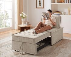 a man is reading a book while sitting on a bench in the living room with his feet up