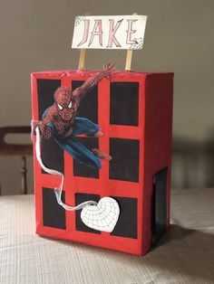 a paper bag with a spiderman on it and a sign that says,'i love you '