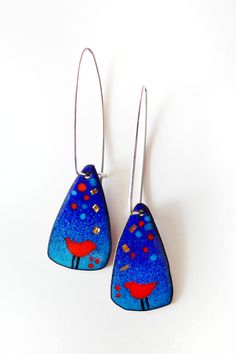 two blue earrings with red birds on them