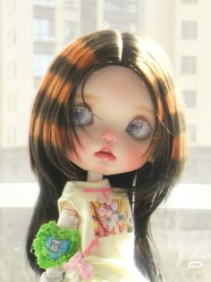 a close up of a doll with long hair