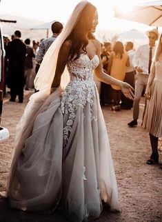 a woman in a wedding dress standing next to a van