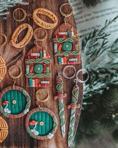 wooden keychains with different designs on them sitting next to a christmas ornament