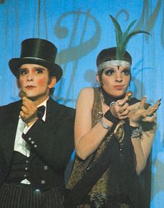 two people dressed in costume posing for the camera