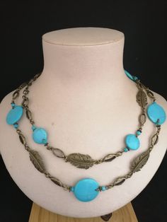 "Details *Handmade items  *Dispatches from a small business in Australia  *Materials: Gemstones, Bronze Fittings  *Gemstone: Turquoise  * Long Necklace: 42\" or 106 cm  * Closure: Lobster clasp  *Chain style: Bead  This gorgeous blue turquoise necklace never goes unnoticed. It features 25, 15 and 4 mm round turquoise stones. Set in bronze, and beautiful filigree leaf sharm are perfect suited with blue stones. This necklace measures 106 cm long. All the beads are individually treaded on antique Bronze pins and dressed in antique brass leaves connectors to give necklace perfect looking.  This turquoise beaded Necklace would be a perfect accessory to add a touch of color to any outfit. The stunning combination blue turquoise stones and bronze give it unique. Complete your look with a turquois Handmade Adjustable Vintage Turquoise Necklace, Handmade Long Turquoise Necklaces, Vintage Adjustable Turquoise Beaded Necklaces, Handmade Turquoise Long Necklace, Turquoise Long Handmade Necklace, Adjustable Vintage Turquoise Beaded Necklace, Vintage Adjustable Turquoise Beaded Necklace, Handmade Long Turquoise Necklace, Handmade Adjustable Blue Turquoise Necklace