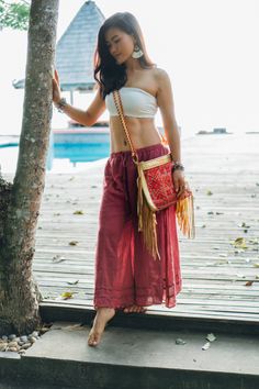 "If you're into luxe casual or softer bohemia, This bag is a must in your closet! It is made with an amazing piece of fabric woven by the HMONG hill tribes of Lanna Region (Northern Thailand). It features gold metallic leather, cotton lining and a zipper closure. Hook it up with any stunner from your boho chic wardrobe. We buy materials from Hmong market and we design and sew by hand. Some of the bags we modify to improve the product. The Hmong tribes live in the North of Thailand and have origi Bohemian Pouch Bags For Vacation, Embroidered Shoulder Bucket Bag For Travel, Summer Bohemian Hobo Pouch Bag, Bohemian Summer Pouch Hobo Bag, Bohemian Crossbody Bucket Bag For Festivals, Bohemian Summer Hobo Bag In Pouch Shape, Bohemian Festival Crossbody Bucket Bag, Beach Shoulder Bag With Tassels In Pouch Shape, Bohemian Pouch Bucket Bag For The Beach