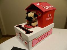 a stuffed dog in a red and white box with love written on the side, sitting inside