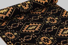 an old black and orange rug with geometric designs