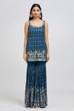 Navy blue kurta with all over embroidery in floral pattern using sequin work. Paired with a sharara with all over sequins embroidery and dupatta. - Aza Fashions Blue Anarkali Sleeveless Set, Blue Sleeveless Anarkali Set, Bollywood Blue Sleeveless Sets, Traditional Blue Sleeveless Sharara, Sleeveless Blue Sets For Diwali, Blue Fitted Sleeveless Sharara, Blue Sleeveless Sets For Reception, Sleeveless Blue Sets For Reception, Blue Sleeveless Set For Reception