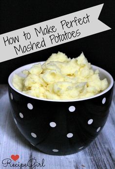 a bowl filled with mashed potatoes sitting on top of a wooden table next to a black and white polka dot bowl