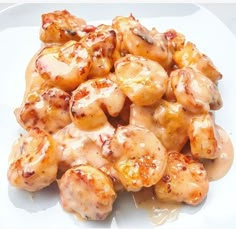 a white plate topped with chicken covered in sauce