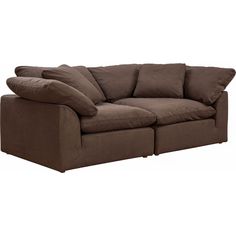 a large brown couch with pillows on it's back and two sides facing each other