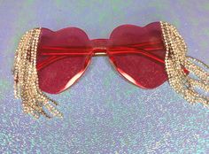 Add some easy glitz to your 'fit with these red heart shaped sunnies loaded up with rhinestone dangles and chain details! Heart Effect Sunglasses, Red Star Sunglasses, Rhinestone Heart Sunglasses, Red Heart Shaped Sunglasses, Fun Red Heart-shaped Sunglasses, Red Heart, Eyewear Sunglasses, Sunnies, Sunglasses Accessories