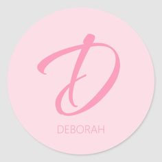 a round sticker with the letter d in pink