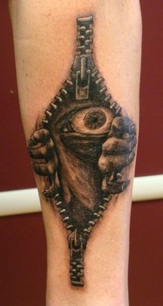 a black and white tattoo on the leg of a person with an eye in it