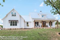 a large white house sitting on top of a lush green field