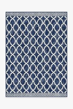 a blue and white rug with an intricate design