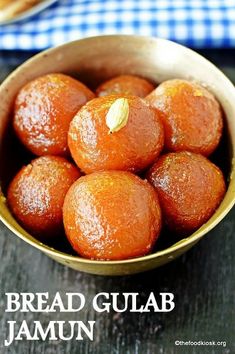 a bowl full of bread gulab jamun sitting on top of a wooden table