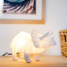 a white rhino lamp sitting on top of a wooden table