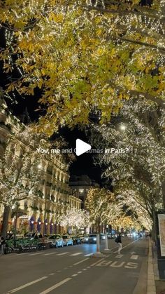 the street is lined with christmas lights and trees