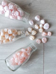 three glass jars filled with pink and white marshmallows