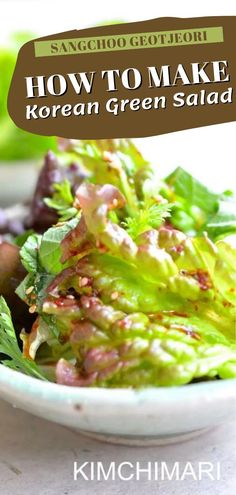 a white bowl filled with green salad on top of a table