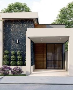 the front entrance to a modern home with trees in the background