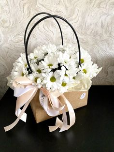 a basket filled with white flowers on top of a table