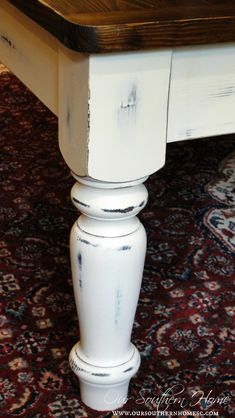 a white table sitting on top of a carpeted floor