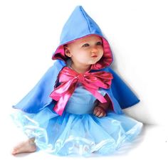 a baby dressed in a blue and pink costume