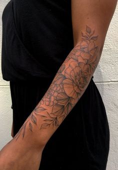 a woman with a flower tattoo on her arm