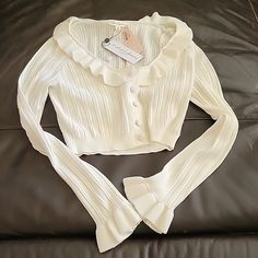 Nwt For Love And Lemons Cardigan With Ruffles Size Medium. Cream/Beige Color Feminine White Long Sleeve Cardigan, White Ruffled Sweater For Spring, Fitted White Sweater With Ruffles, Feminine White Cardigan For Fall, White Casual Cardigan With Ruffles, White Casual Ruffled Cardigan, White Ruffled Cardigan For Spring, Casual White Ruffled Cardigan, White Ruffled Cardigan For Fall