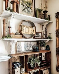 an old wooden shelf with various items on it and a clock mounted to the wall