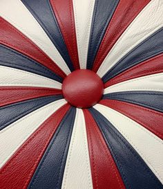 a red, white and blue umbrella is shown with the center circle painted on it