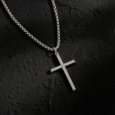 Wear your faith proudly with this men's cross necklace. This beautiful statement piece is crafted in sterling silver with 14k white gold plating and sits on a sturdy 24-inch gold plated stainless steel chain. The Paved Cubic Zirconia stone cross necklace for him showcases your faith and belief. It adds protection and a unique look to your wardrobe. Discover all our sleek 925 silver jewelry for men and find a gift for him HERE Made with white gold plated 925 sterling silver. Color: White Dimensio Silver Cross Pendant Necklace For Father's Day, Father's Day Silver Cross Pendant Necklace, Sterling Silver Cross Necklace With Box Chain, Silver Cross Necklace With Box Chain, Silver Crucifix Cross Necklace With Box Chain, Cross Neckless, Silver Jewelry For Men, Mens Silver Chain Necklace, Necklace For Him