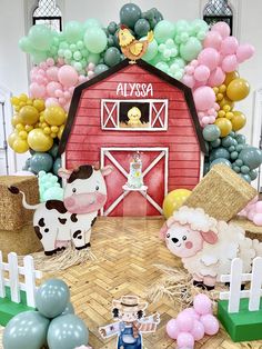 a barnyard with balloons and farm animals on the floor for an outdoor birthday party