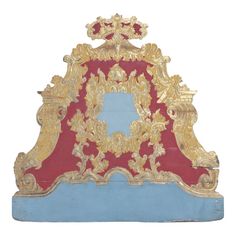 a red and blue clock with gold decorations on it's face, sitting in front of a white background