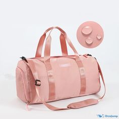 a pink duffel bag sitting on top of a white floor next to a round object