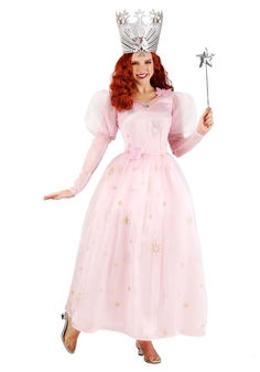 a woman in a pink dress and tiara is holding a wand with both hands