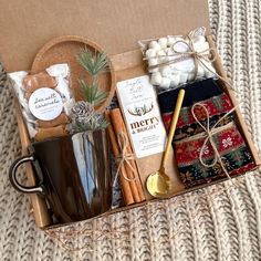 a gift box with coffee, marshmallows, cinnamon sticks and other items